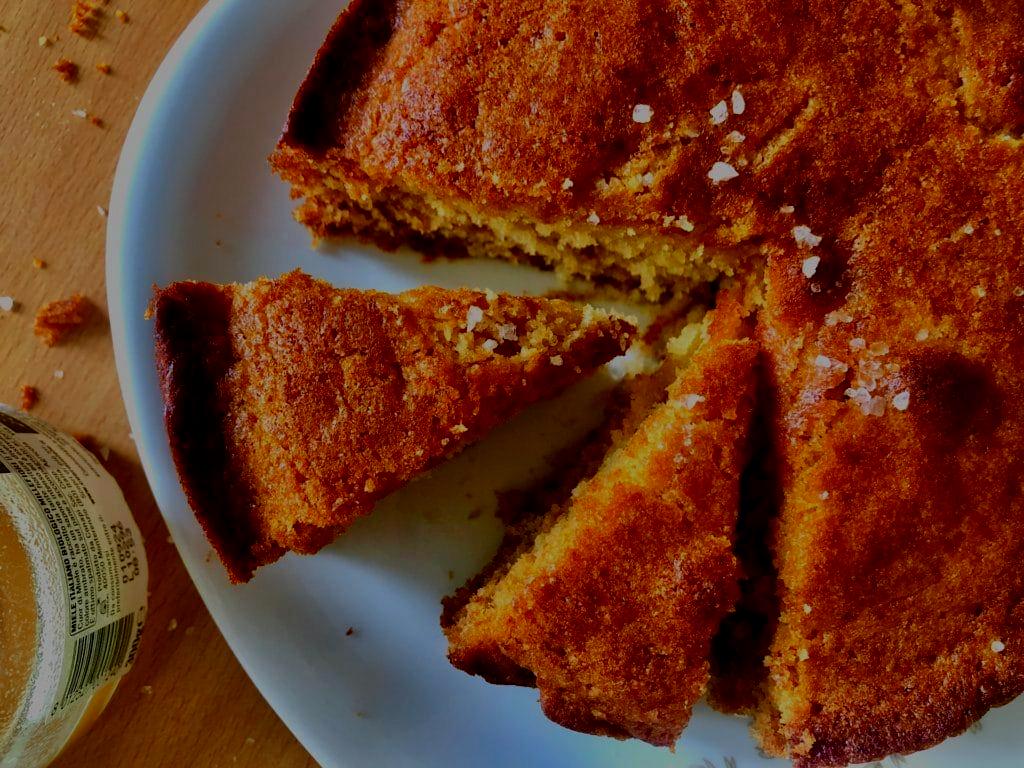 Close-up of a slice of honey and herb cake with a glistening salted honey drizzle